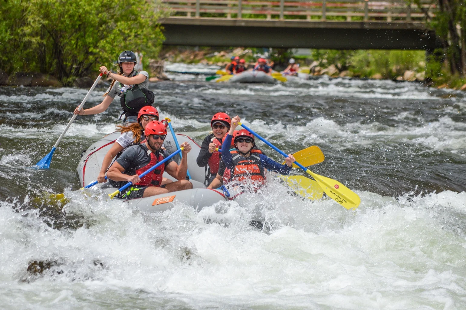 Clear Creek Rafting - group paddling through rapids in Idahor Springs near Denver, CO