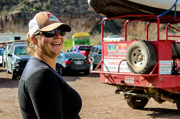 A woman smiles at the camera at the Salt River outpost