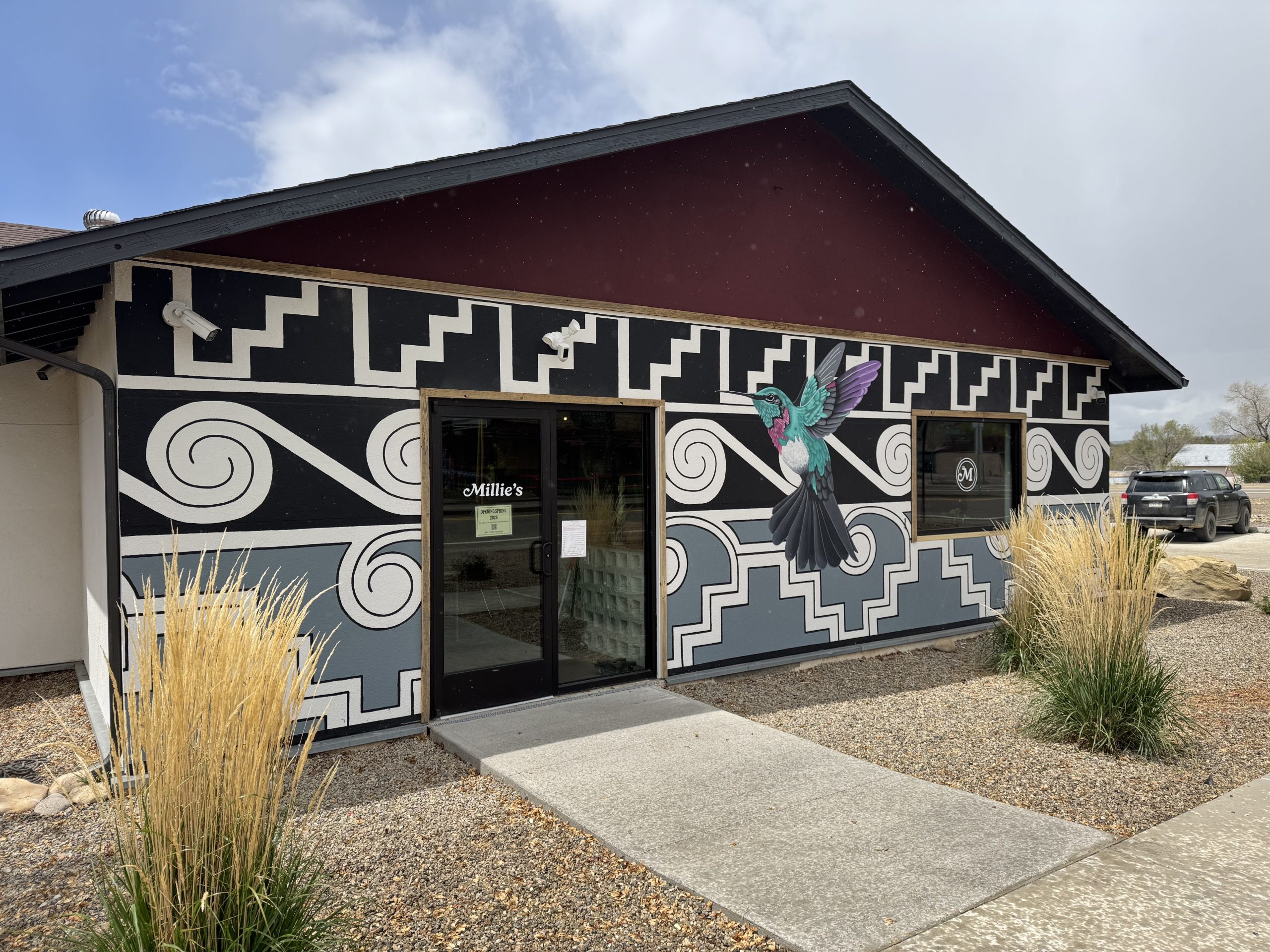 Western style mural with hummingbird on the wall of the Mancos Visitor Center.