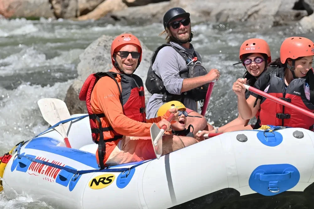 family smiling and laughing rafting in Browns Canyon National Monument