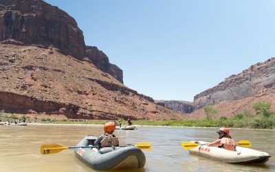 Two inflatable kayakers on the colorado river in castle valley, moab Utah